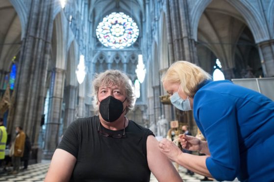 Stephen Fry receiving his vaccine in London