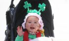 18-month-old Grace Wang dressed up to celebrate St Patrick's Day on O'Connell Street in Dublin. Picture date: Wednesday March 17, 2021. PA Photo. See PA story IRISH StPatricks. Photo credit should read: Brian Lawless/PA Wire