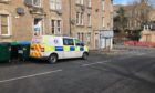 To go with story by James Simpson. Police reportedly at the scene in connection with the on-going murder investigation in Ardler. Picture shows; A police van on Main Street. Dundee. James Simpson/DCT Media Date; 10/03/2021