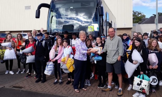 Dundee-Orleans Twinning Association president Sally Carus presents a cheque to Morgan Academy French teacher  Erwan Ansquer before the group left Dundee for Orleans in June 2019.