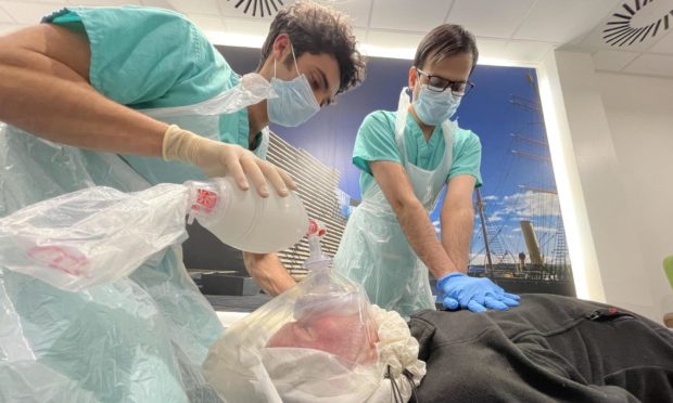 CPR personnel Rashad Misirovs, left, and Ruqqash Naveed try out the Sarus-CPR.