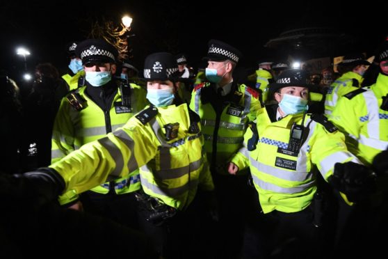 Police officers clash with people as they form a gathering in Clapham Common, London, after the Reclaim These Streets vigil for Sarah Everard was officially cancelled.