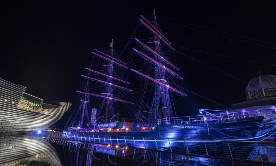 Discovery Point lit up at night.