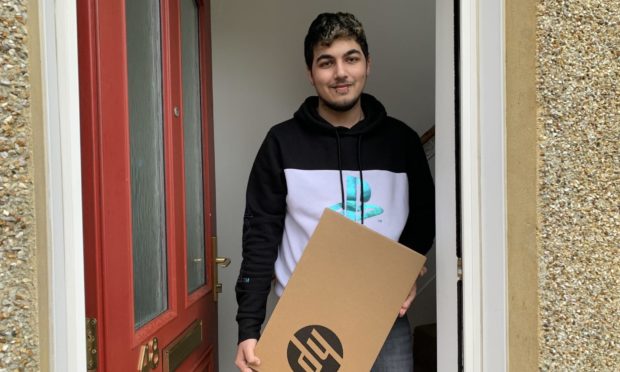 Raheem Akhtar takes delivery of his new laptop.