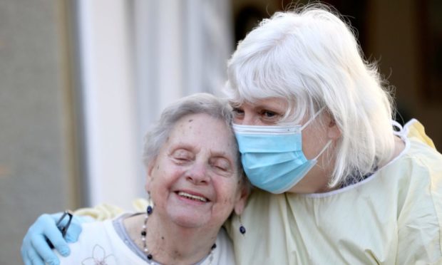 Mary Cook (left), 90, receives her first visit in three months from her daughter, Fiona Scott, at Queen's House in Kelso, in the Scottish Borders, as regular visiting resumes in Scottish care homes following the successful roll-out of the vaccination programme, with almost all residents receiving their jabs.