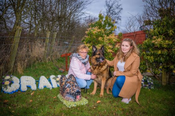 Belinda Robertson and daughter Joni Davidson with six-year-old German Shepherd, Boss.