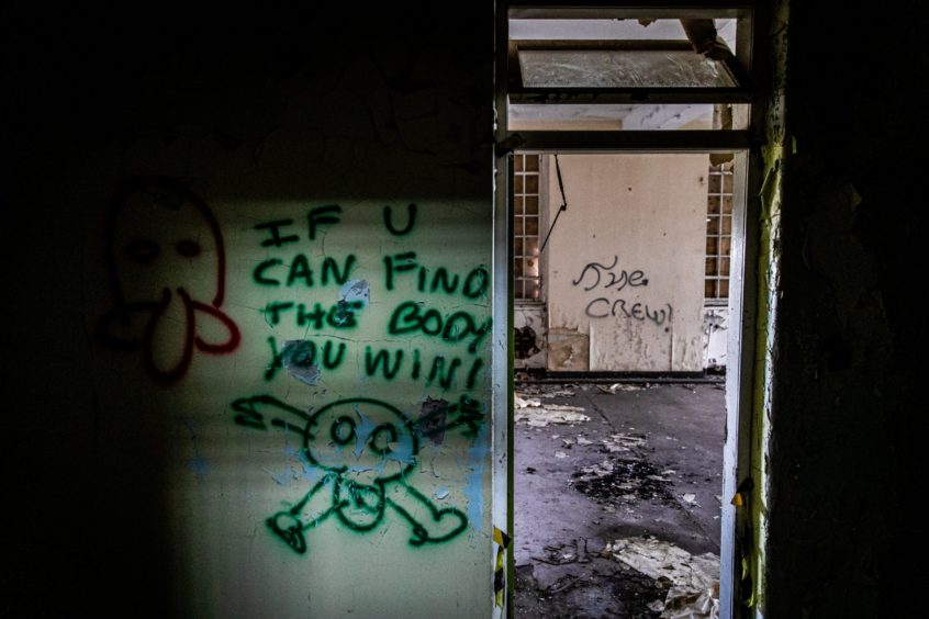 Grim graffiti inside Strathmartine Hospital.
