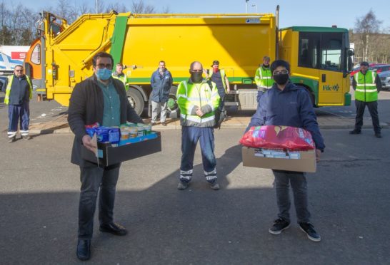 Ahmadiyya Muslim Community representatives Hassan Hakeem (left) and Saqib Ahmad (right) with driver Neil Strachan (centre) delivering healthy snacks to the Dunfermline bin crew.