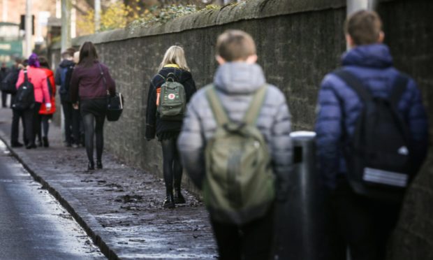 The Courier, No CR number, News, Harris Academy pupils leaving school today after it was annouced schools are closing due to the coronavirus. Picture shows; pupils leaving at the end of the school day. Wednesday 18th March, 2020. Mhairi Edwards/DCT Media
