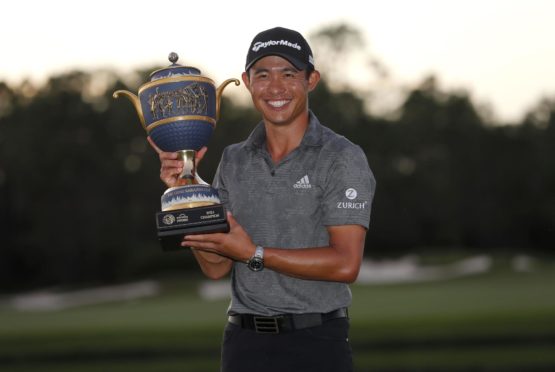 Collin Morikawa of the US celebrates with the WGC trophy.