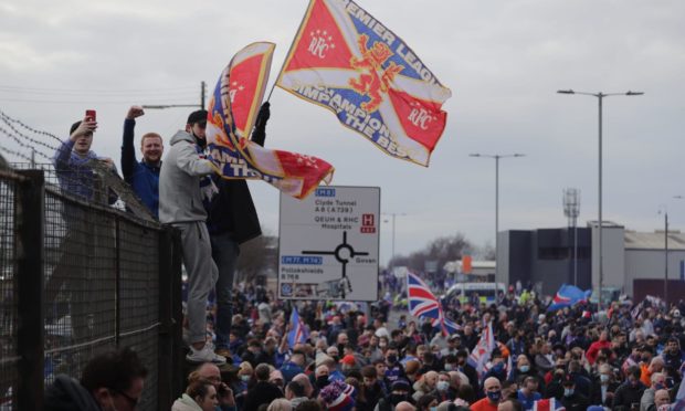 Rangers fans celebrate the Glasgow side winning the league.