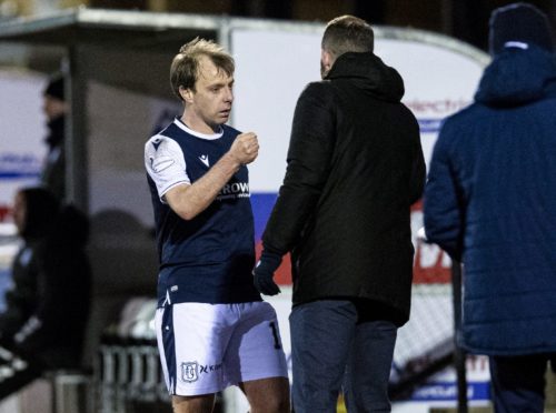 Dundee midfielder Paul McGowan has triggered a contract extension to remain at Dens Park until, at least, next summer.