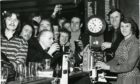 Time gentlemen please! Drinkers are put on the clock at the Highwayman in the Hilltown in 1976.