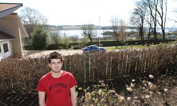 Cailean Graham in his parents' garden in Primrose Bank, which overlooks part of the site.
