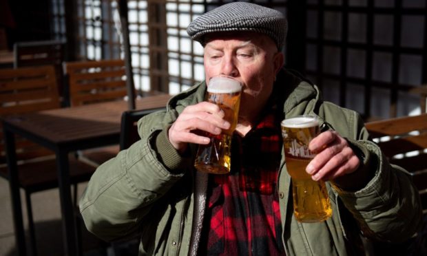 John Witts enjoys a drink at the reopening of the Figure of Eight pub, in Birmingham, as England takes another step back towards normality with the further easing of lockdown restrictions. Picture date: Monday April 12, 2021. PA Photo. Facilities permitted to reopen in the latest easing of lockdown include pubs and restaurants who can serve outside, non-essential shops, indoor gyms and swimming pools, nail salons and hairdressers, outdoor amusements and zoos. See PA story HEALTH Coronavirus. Photo credit should read: Jacob King/PA Wire