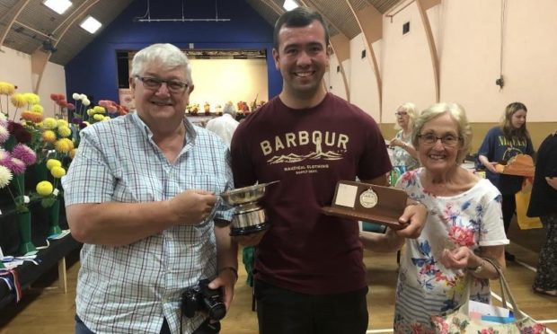 Calum Clunie wth his grandparents Alasdair and Sheila Simpson at the Leven show