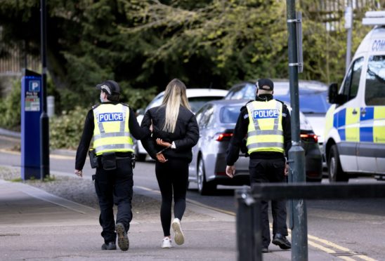 Police lead on youth away in handcuffs after police broke up a large gathering at a Perth beauty spot on Friday evening.