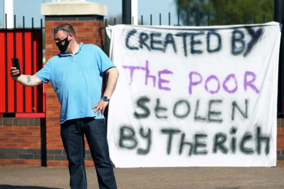 A fan outside Manchester United's Old Trafford ground.