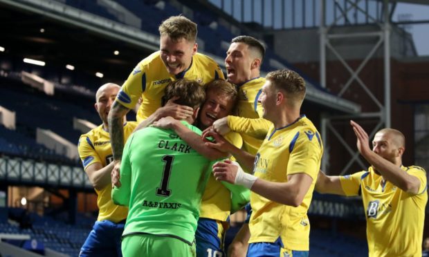 St Johnstone players celebrate with goalkeeper Zander Clark after winning the penalty shoot-out against Rangers