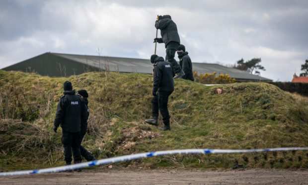 Police and forensics officers searching after human remains were discovered on Sunday morning.