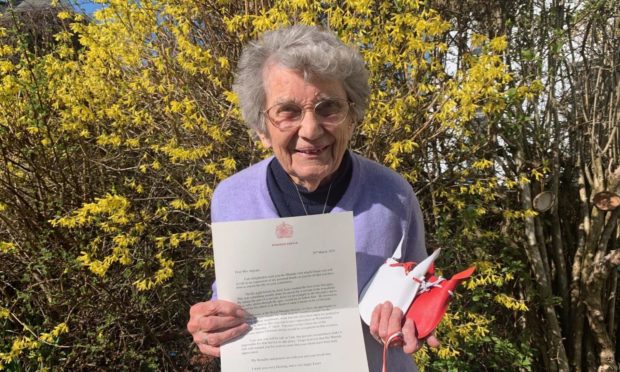 Margaret Ingram with her award and letter from the Queen. 