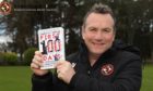 Dundee United manager Micky Mellon poses with his management book: The First 100 Days.