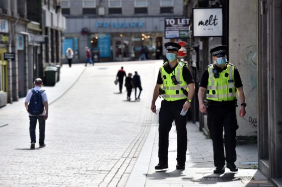 Police officers patrol Union Street and Belmont Street in Aberdeen.