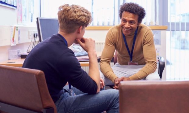 Male College Student Meeting With Campus Counselor Discussing Mental Health Issues; Shutterstock ID 1704719680; Purchase Order: The Courier health and wellbeing team; Job: Sudents mental health; 6fd2eb0d-5c13-4805-91d5-0dd271a4fe01