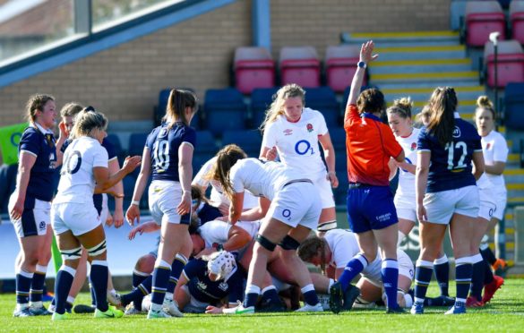 Poppy Cleall scores one of England's eight tries in their 52-10 win.
