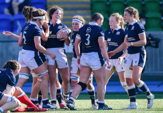 Scotland's play-everywhere forward Christine Beleisle (with ball) celebrates her first try for her country.