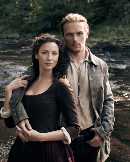 Caitriona Balfe as Claire Randall and Sam Heughan as Jamie Fraser in Outlander.