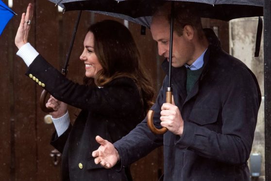 The wet weather couldn't dampen the Royal couple's spirits as they returned to St Andrews.
