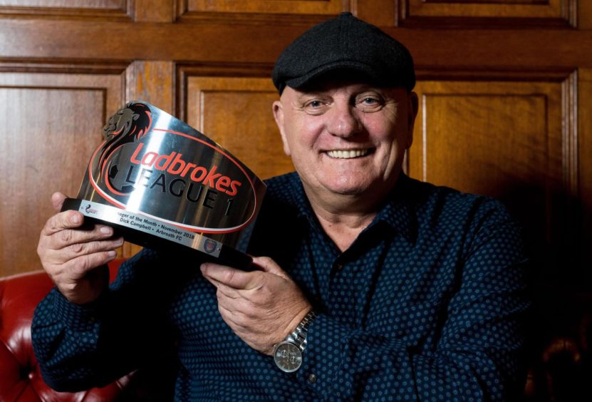 Dick Campbell holding the Ladbrokes League 1 Manager of the Month trophy.