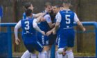 Graham Webster is mobbed by his Montrose teammates after giving his side the lead over Morton in last season's play-offs.