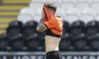 Dundee United left-back Jamie Robson looks dejected after being sent off against St Mirren.