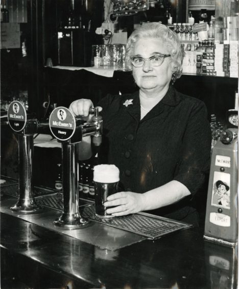 Legendary Dundee barmaid Isobel Mennie pouring a pint in 1972 in Speedwell Bar, Perth Road