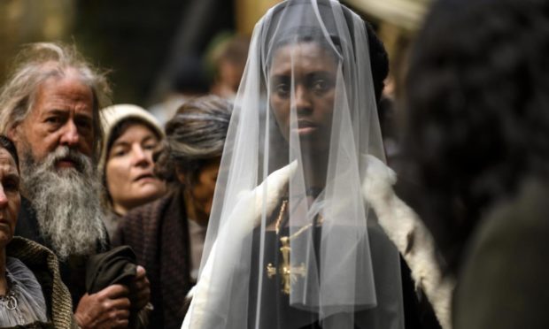 Anne Boleyn (Jodie Turner-Smith) surrounded by subjects.