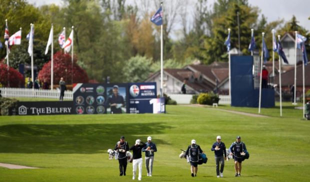 MacIntyre, and playing partners Martin Kaymer and Denmark's Rasmus Hojgaard walk from the 1st tee at the Belfry.