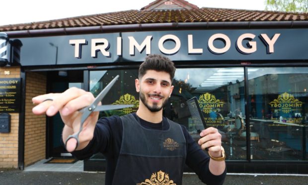 Ary outside his barber shop in Dundee.