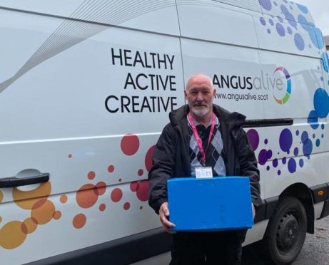 Alan Martin of Angus Alive with a selection of books for home delivery.