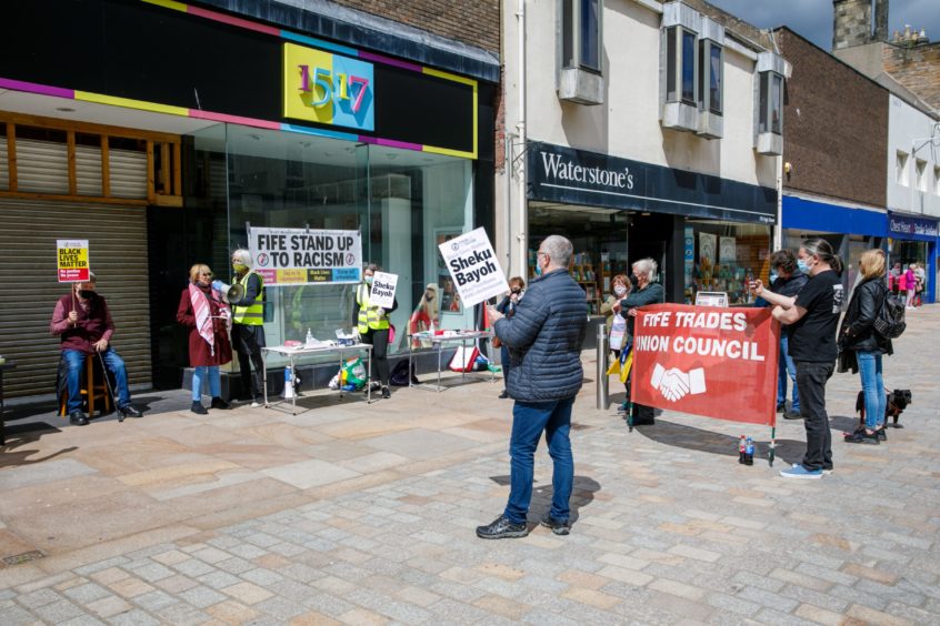 A protestor in Kirkcaldy, showing his support following the death of Sheku Bayoh, left.