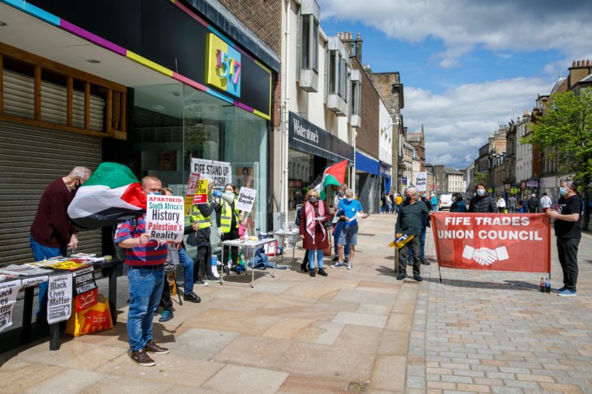 A protestor in Kirkcaldy, showing his support following the death of Sheku Bayoh, left.