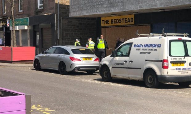 Officers in Lochee High Street.