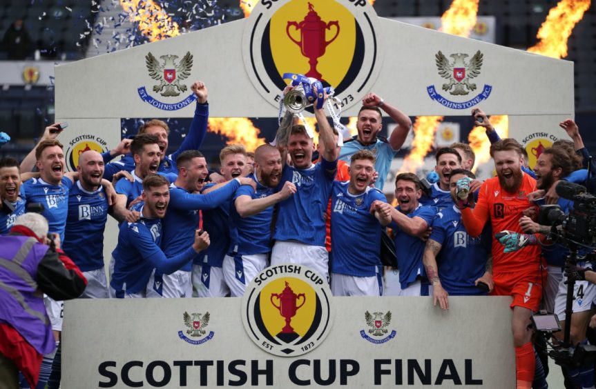 St Johnstone's Jason Kerr lifts the trophy after the final whistle during the Scottish Cup final match at Hampden Park, Glasgow. Picture date: Saturday May 22, 2021. PA Photo. See PA story SOCCER Final. Photo credit should read: Andrew Milligan/PA Wire. RESTRICTIONS: Use subject to restrictions. Editorial use only, no commercial use without prior consent from rights holder.