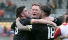 Livingston's Shaun Byrne (left) and Lee Miller with manager David Hopkin celebrate promotion with Livingston.