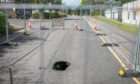 Police sealed off the road after the sink hole appeared on Monday evening.