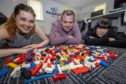 Kingdom FM DJs Gemma McLean, Dave Connor and Vanessa Motion will settle the argument that Lego is the most painful thing to stand on by walking across broken glass.