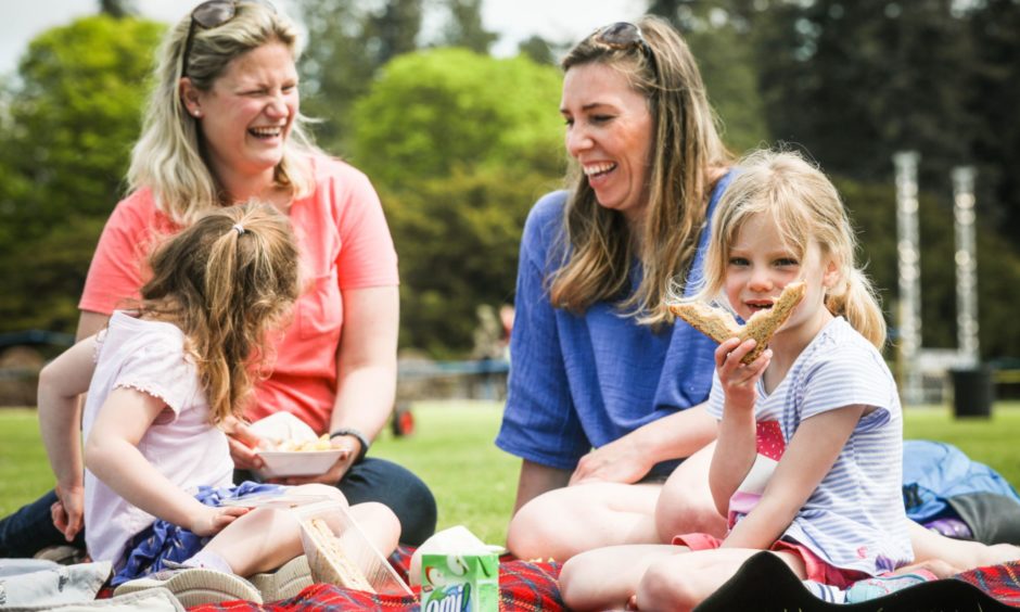 Suzannah Hopkinson, 5, and Flossie Moffat, 5, with Gemma Scott (back left) and Calli Hopkinson (back right) enjoying their picnic.