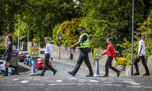 P7 pupils Neave Donaldson, Ben Hilton-Christie, Harvey Ritchie and Oliver Stewart with PC Scott Menmuir as they learn safety skills.