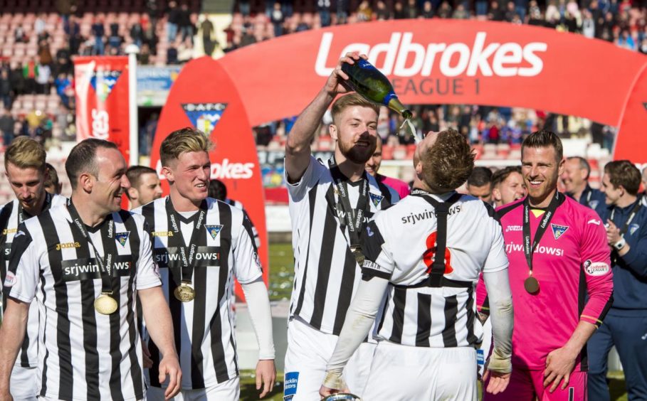 Shaun Rooney celebrating with his Dunfermline team mates as they win Scottish League 1